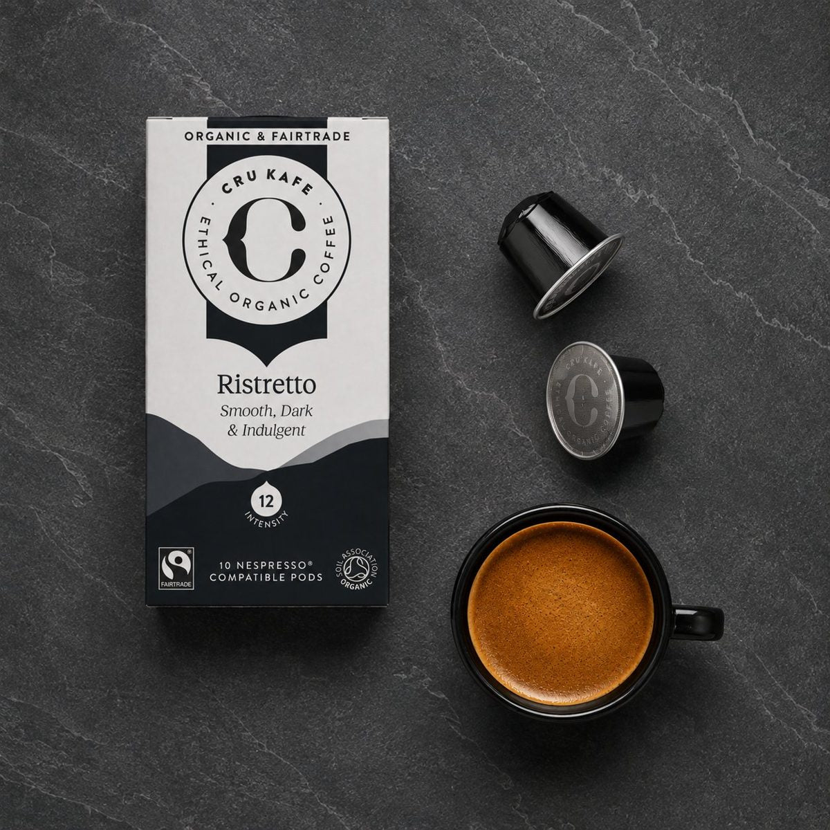 CRU Ristretto pods and a cup of coffee on slate